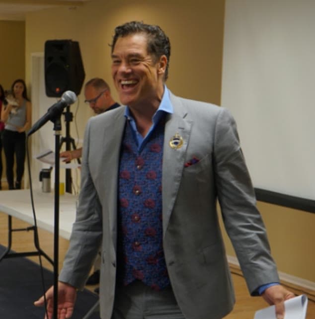 Candid portrait of Tom Cummins at a microphone