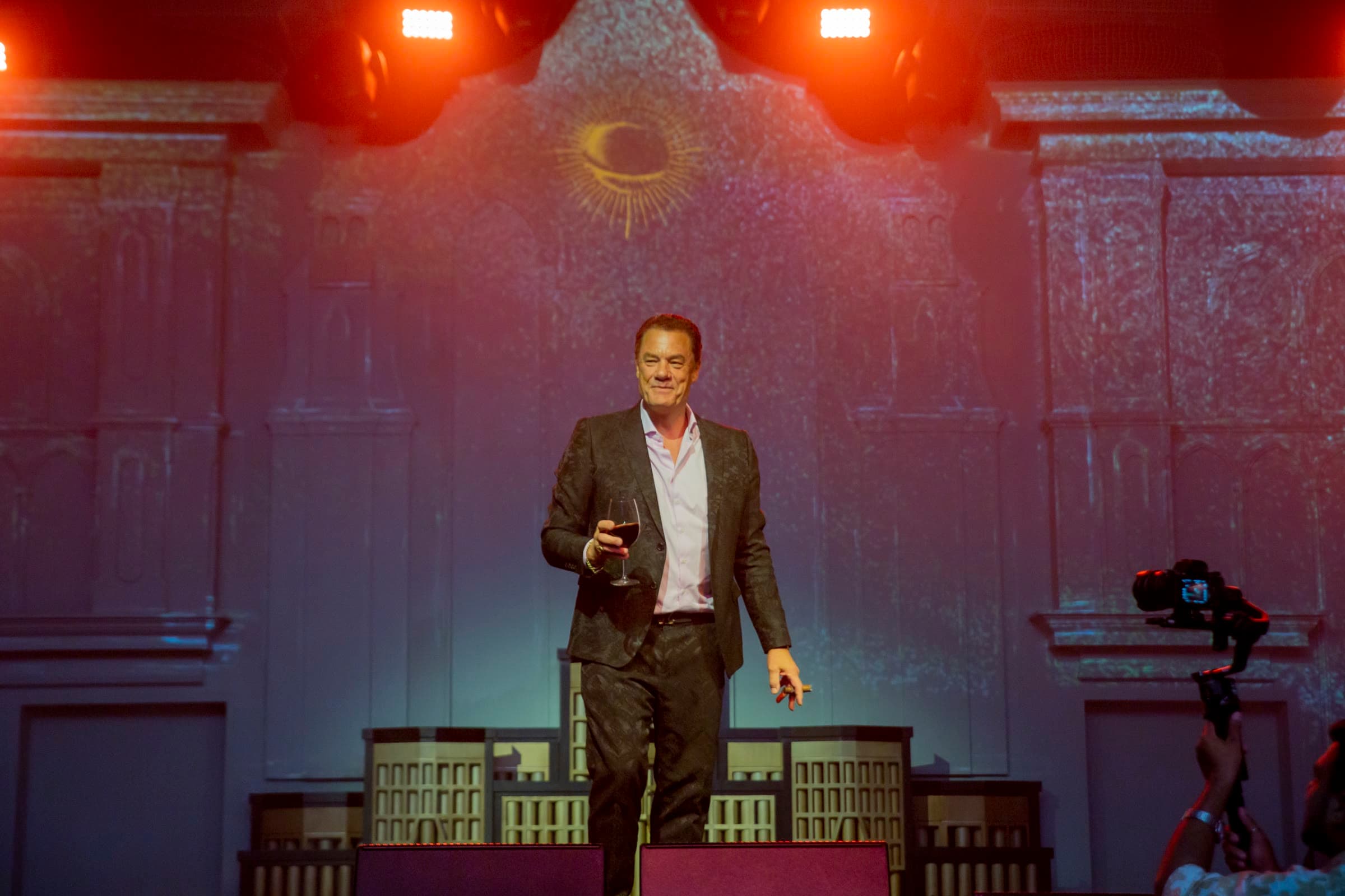 Tom Cummins alone on a theatrical stage