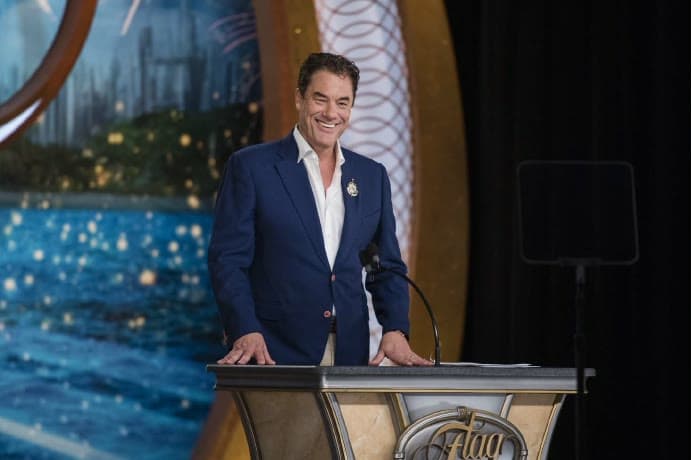 Tom Cummins at an ornate gala podium